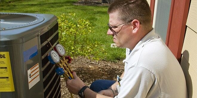 Technician testing HVAC equipment during an emergency repair