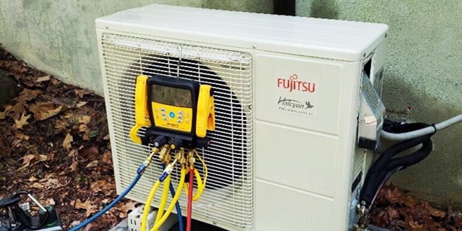 Technician repairing an air conditioning unit